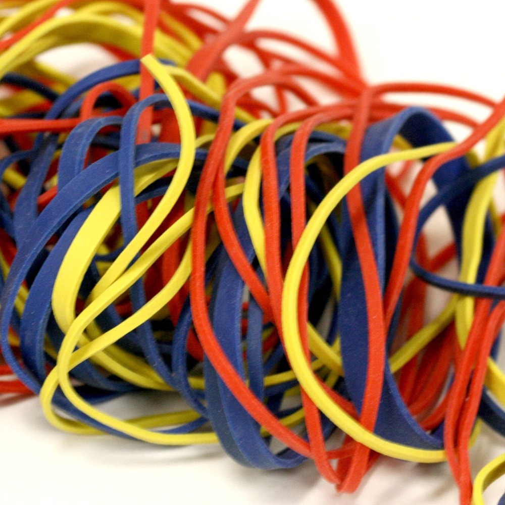 A collection of various sized rubber bands, some twisted and some lying