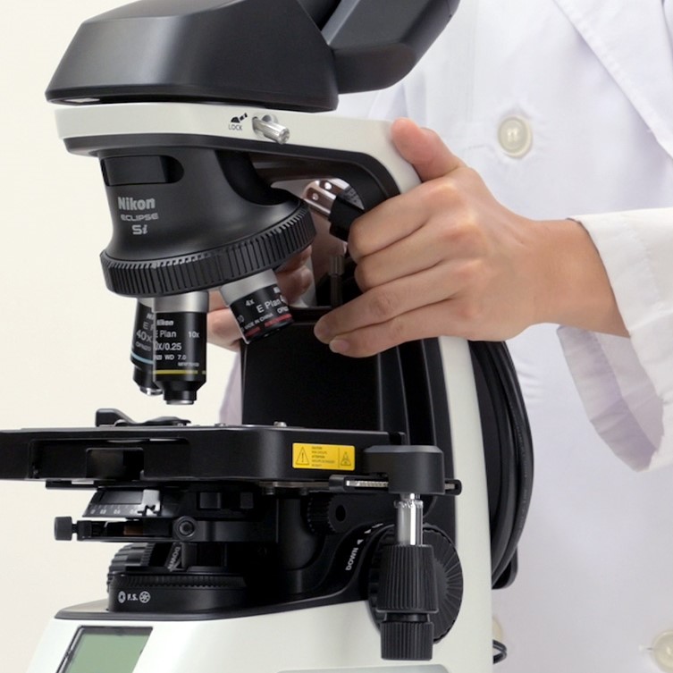 what is the proper way to carry a microscope
