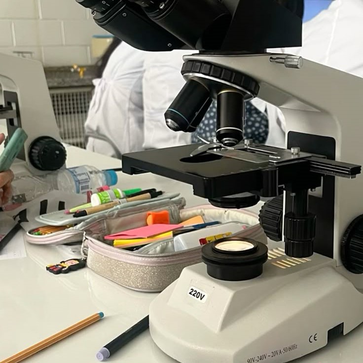 what is the proper way to carry a microscope