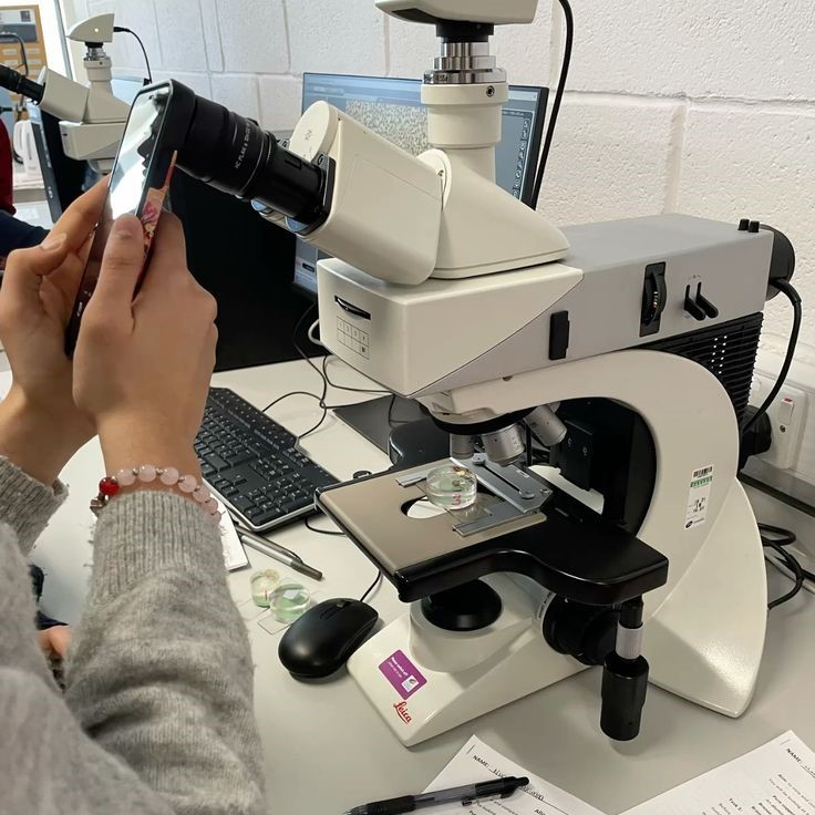 what is the proper way to carry a microscope