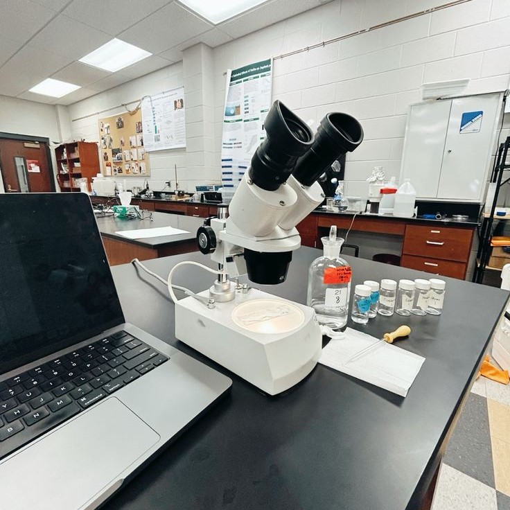 what is the proper way to carry a microscope